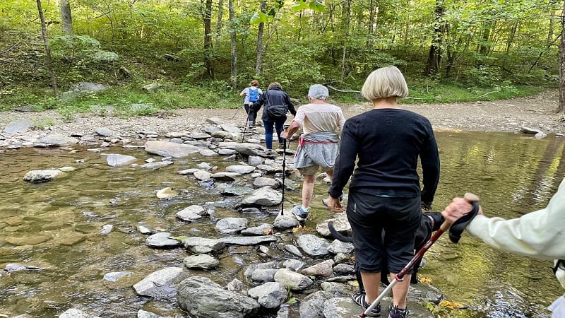 Hikers Crossing a Stream