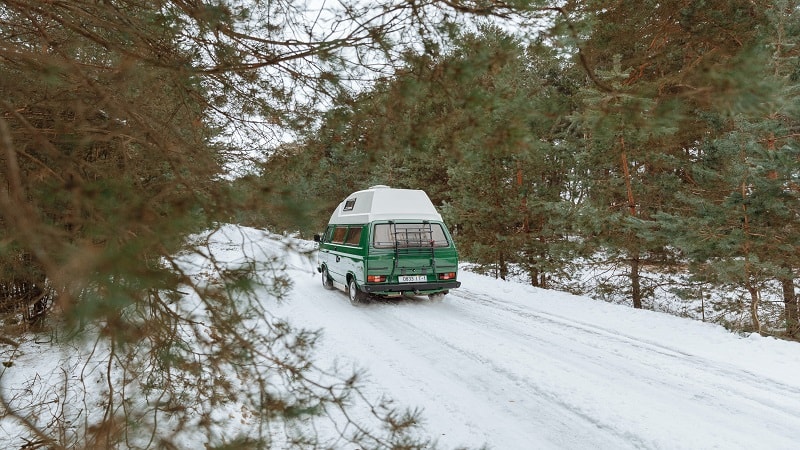 Green Van Driving in Snow