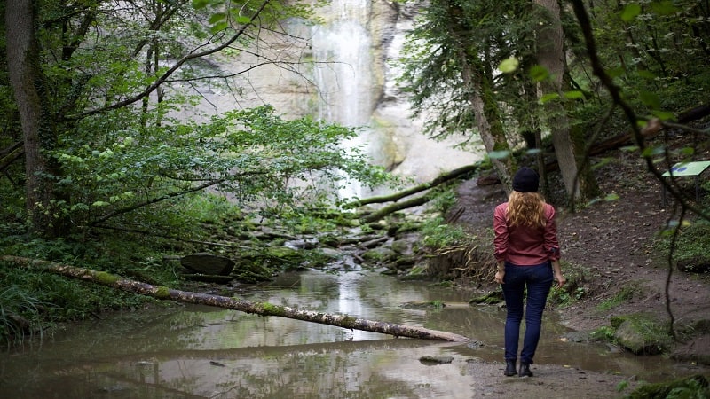 Woman Hiking to a Waterfall - Best Hiking Bras