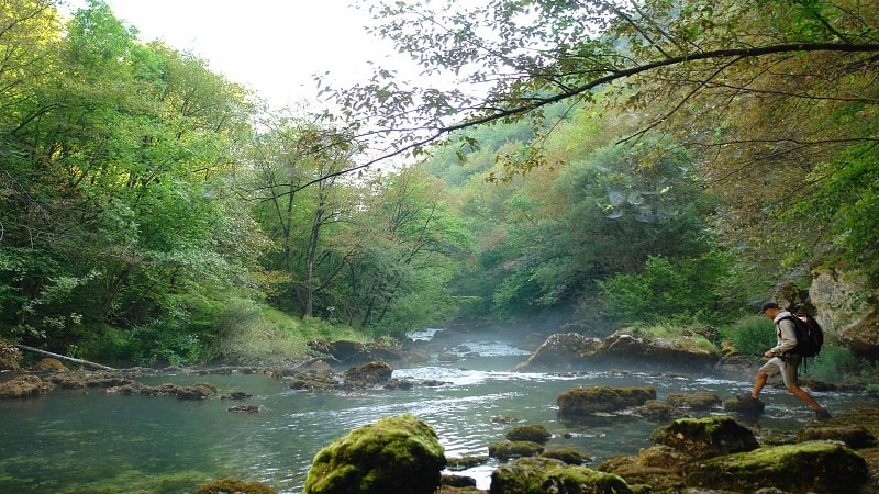 Hiker Crossing Water