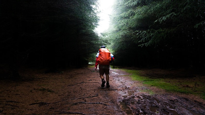 Man Backpacking in the Rain