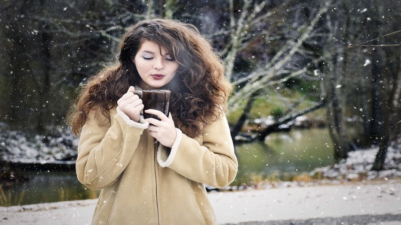 Woman Enjoying Coffee Outside in Winter